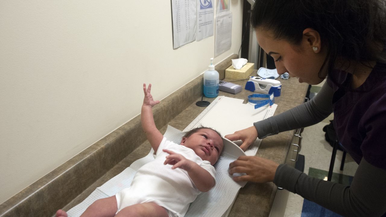 Mariela Duran, a pediatric medical assistant at Inner City Health Center in Denver, Colorado measures three week old Elias Martinez during a visit at Inner City Health Center in Denver, Colorado on March 15, 2017. Inner City Health Center was founded in 1983 and offers medical, dental, and mental and behavioral health services to the uninsured and underserved populace of Denver County and surrounding Colorado communities. Services are offered to patients based on a sliding scale, and 65% of the patient population is below  200% of the federal poverty level. ICHC serves more than 22,000 patients annually.  / AFP PHOTO / Jason Connolly        (Photo credit should read JASON CONNOLLY/AFP/Getty Images)