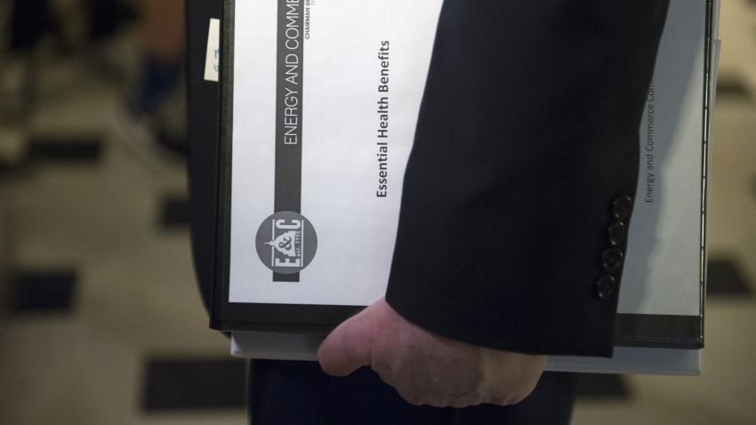 House Energy and Commerce Committee Chairman Rep. Greg Walden, R-Ore., one of the stewards of the Republican health care legislation, carries a binder labeled "Essential Health Benefits" as he leaves the Capitol Hill office of House Speaker Paul Ryan, Friday, March 24, 2017, as the House nears a vote on their health care overhaul. (AP Photo/Cliff Owen)