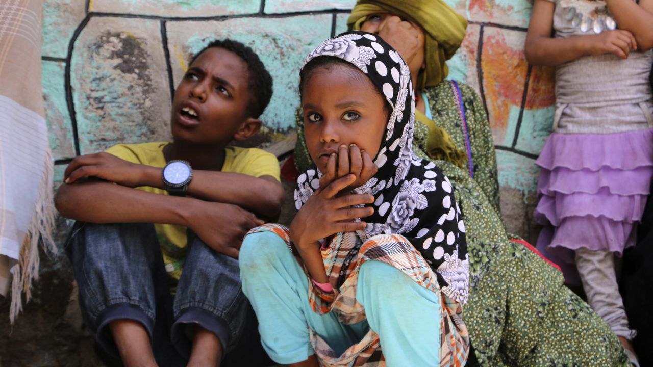 Displaced families who fled fighting in the southern city of Aden wait for relief supplies during a food distribution effort by Yemeni volunteers, in Taiz.