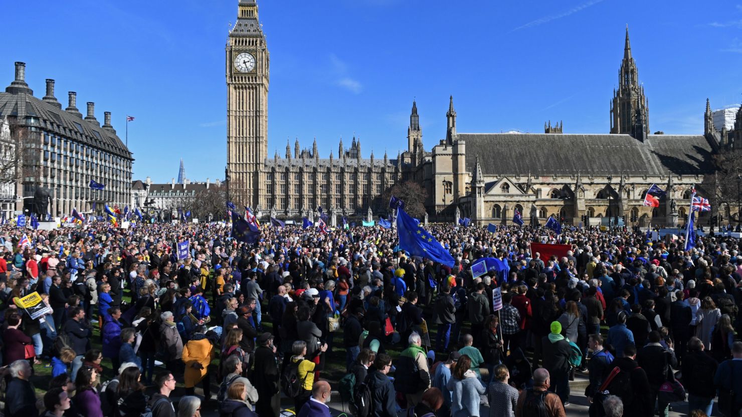 Demonstrators with EU flags gather Saturday near the Houses of Parliament in London.