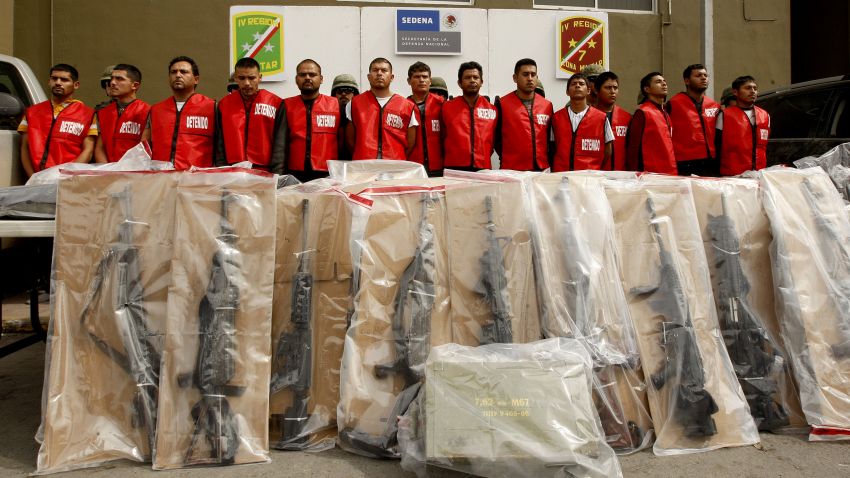 Fourteen alleged members of "Los Zetas" drug cartel and seized weapons are presented to the press in Monterrey, Nuevo Leon state, Mexico on February 15, 2012. More than 40,000 people have been killed in rising drug-related violence in Mexico since December 2006, when President Felipe Calderon deployed soldiers and federal police to take on organized crime. AFP PHOTO/Julio Cesar AGUILAR (Photo credit should read Julio Cesar Aguilar/AFP/Getty Images)