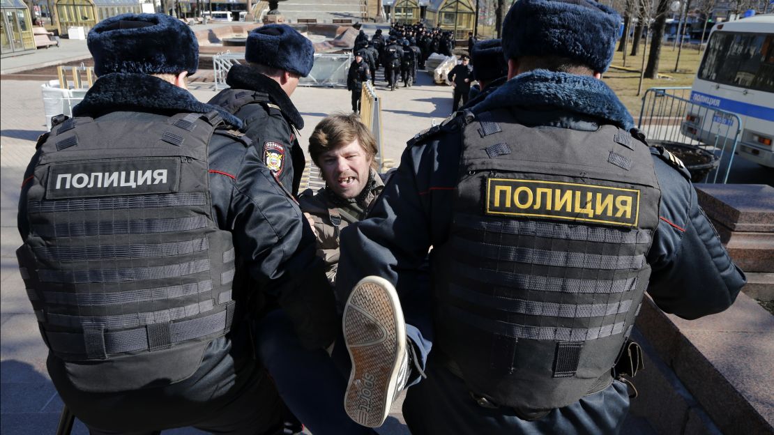 Police detain a protester in central Moscow on Sunday.