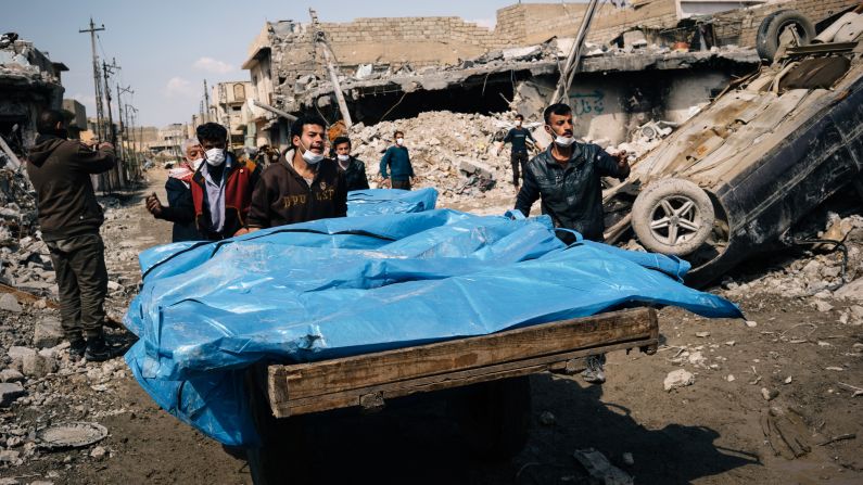 Local volunteers carry the bodies of civilians found in the rubble of a building in the al Jadidah neighborhood of Mosul.