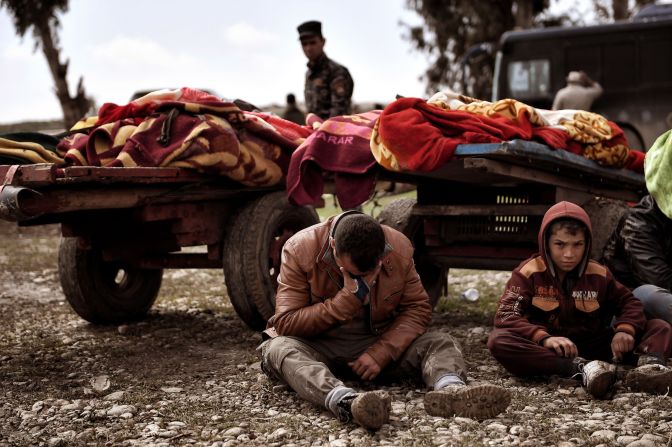 Relatives mourn as bodies of Iraqis killed in a Mosul airstrike are placed on carts on March 17.