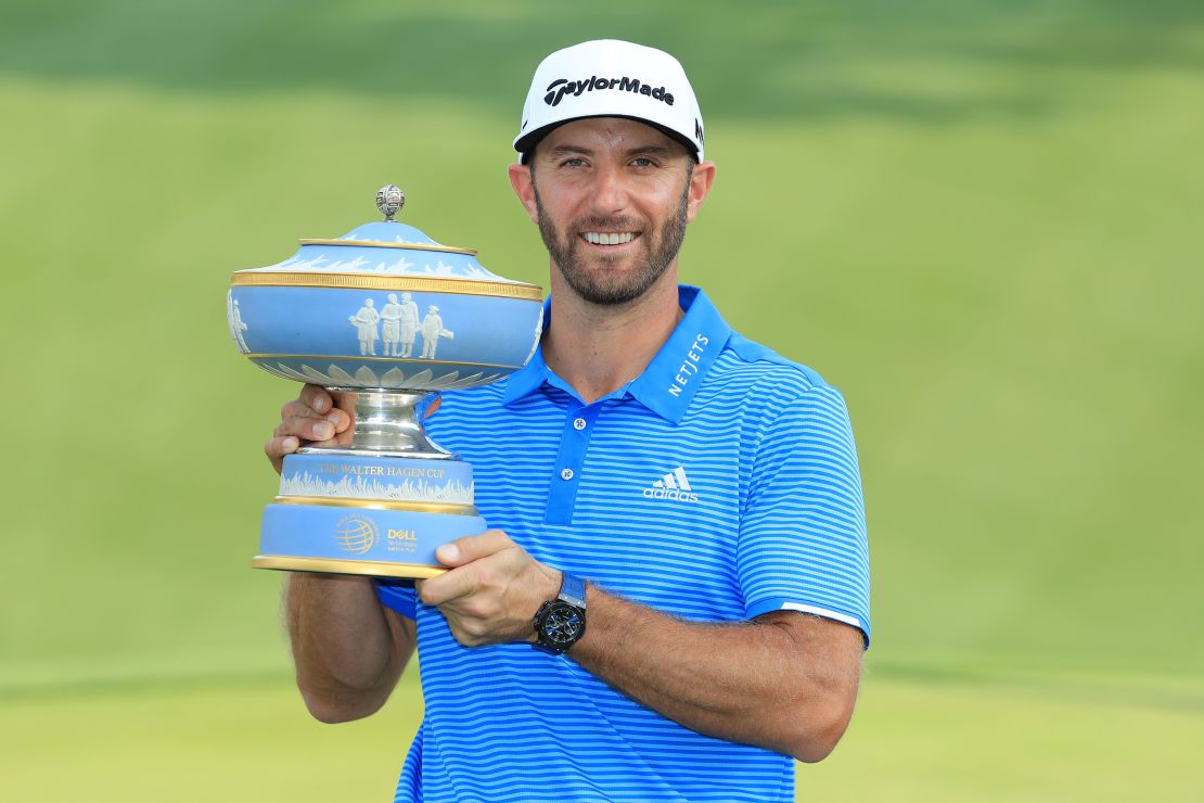 Johnson poses with the trophy after winning the World Golf Championships at the Austin Country Club.