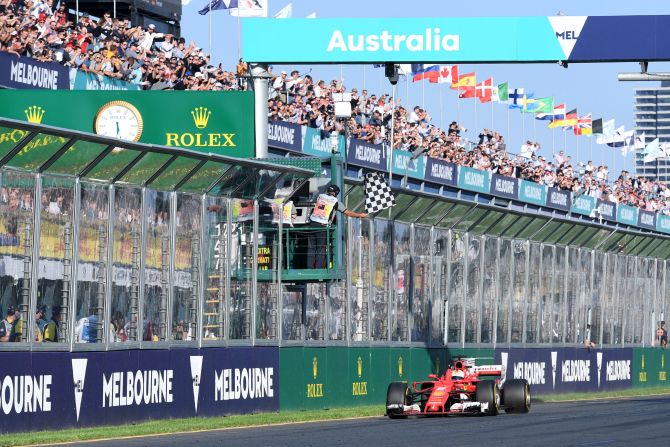 Sebastian Vettel raises a finger in triumph as he crosses the finish line to win the season-opening Australian Grand Prix in Melbourne on Sunday. 