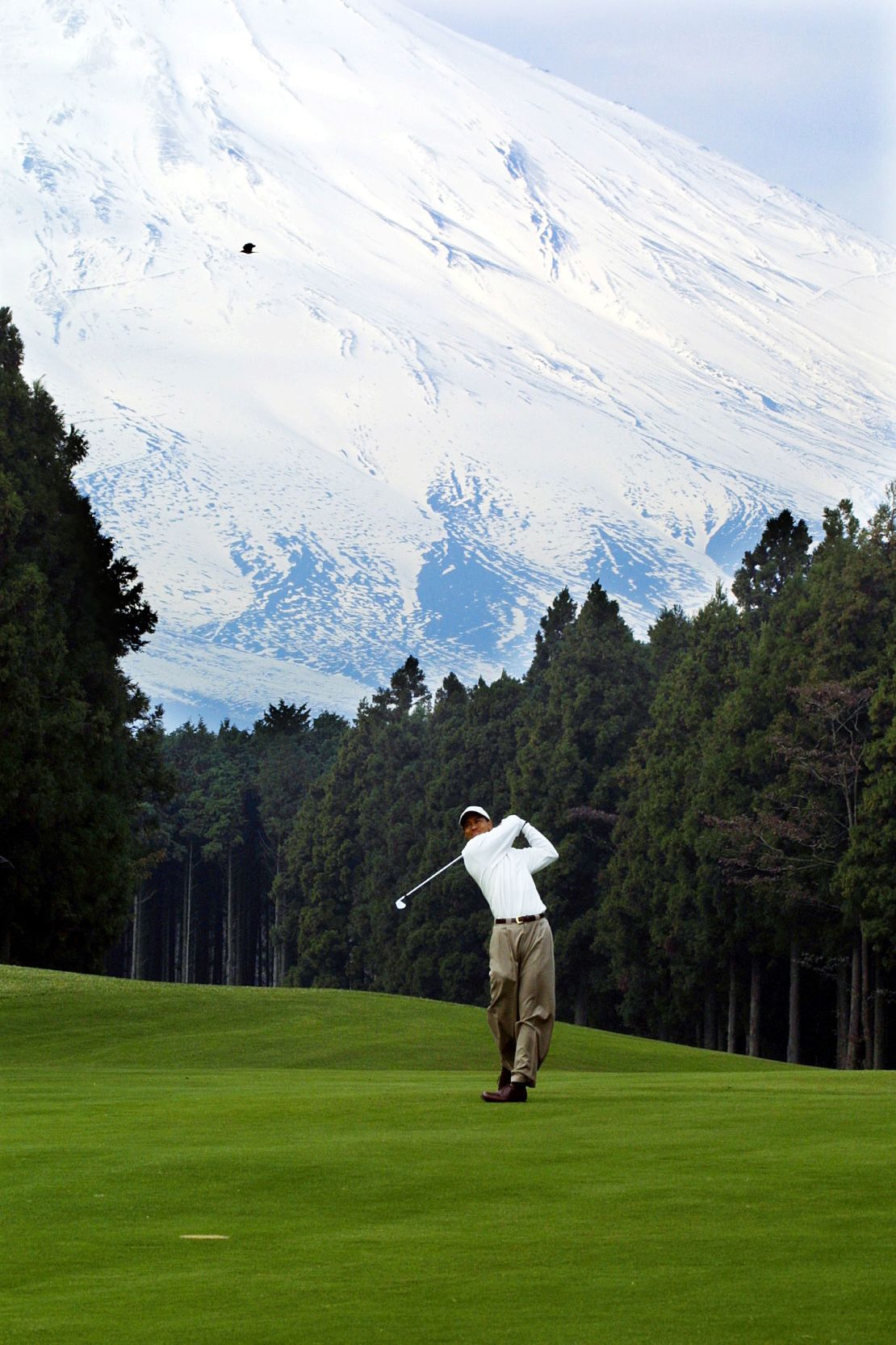 Tiger Woods follows through on a shot at the Gotemba Golf Course near Tokyo, Japan.