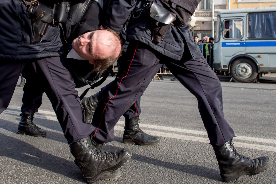 Police officers detain a man during an unauthorized anti-corruption rally in central Moscow on March 26.