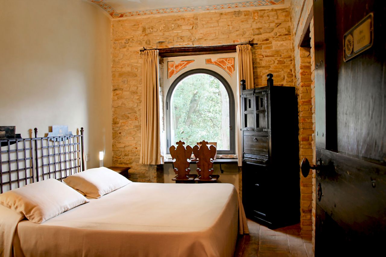 Castello di Monterone's rooms feature exposed stone walls and views over the Umbrian countryside. 