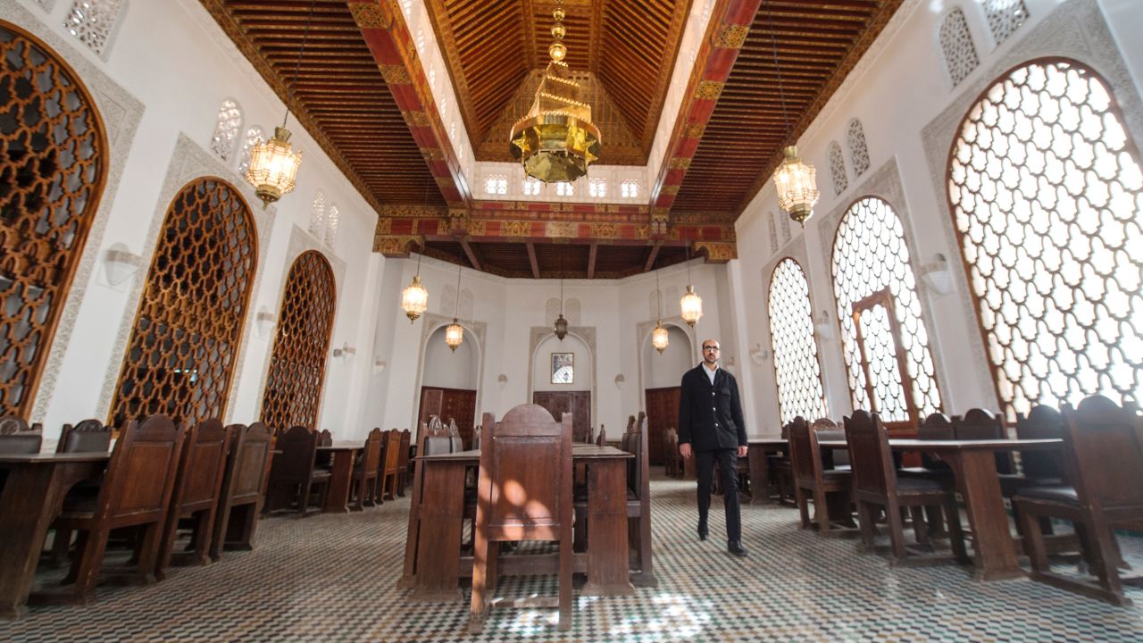 A man walks inside a hall at the al-Qarawyin Library in the Moroccan city of Fez on November 21, 2016.
Nestled in a labyrinth of streets in the heart of Morocco's ancient city of Fez, stands the world's oldest working library. Its sculpted dark wooden door stands almost hidden on the edge of a square where artisans hammer away at copper in a deafening din, delighting passing tourists.
 / AFP / FADEL SENNA        (Photo credit should read FADEL SENNA/AFP/Getty Images)
