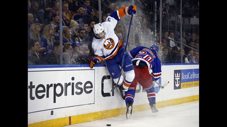 New York Rangers left wing Chris Kreider checks New York Islanders defender Travis Hamonic into the boards at Madison Square Garden on Wednesday, March 22. 