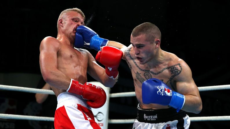 Callum French of British Lionhearts takes a hit from Michael Magnesi of Italia Thunder during the World Series of Boxing at York Hall on Thursday, March 23, in London.