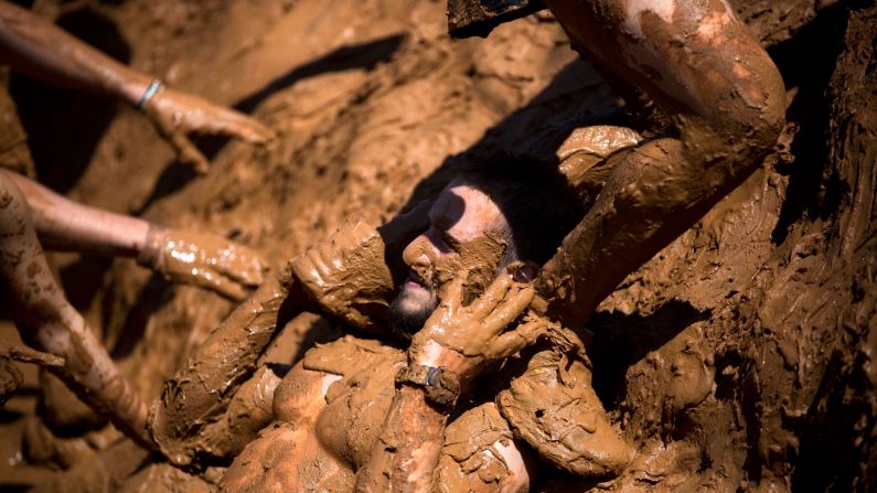 People take part in a Mud Day race, a roughly 8-mile obstacle course in Tel Aviv, Israel, on Friday, March 24. 