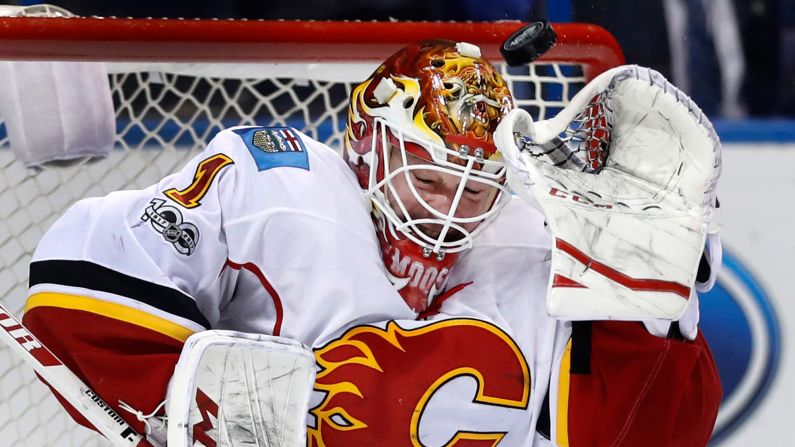 Calgary Flames goalie Brian Elliott braces as a puck sails overhead during the second period of an NHL game against the St. Louis Blues, on Saturday, March 25. 