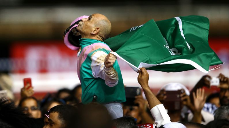 Mike Smith riding Arrogate celebrates winning the Dubai World Cup at the Meydan Racecourse on Saturday, March 25, in Dubai.