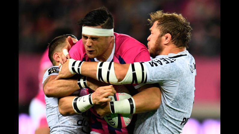 Stade Francais lock Gerhard Mostert, center, vies with RC Toulon's Duane Vermeulen during their French Top 14 rugby union match on Sunday, March 26, in Paris. 