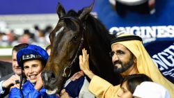 UAE Prime Minister and Ruler of Dubai Sheikh Mohammed bin Rashid al-Maktoum (C-R) celebrates with Jockey William Buick (C-L) and horse Jach Hobbs (C) after they won the Longines Dubai Sheema Cla