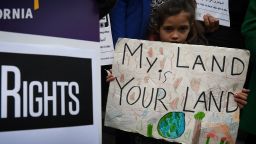 Maya Casillas, 7, joins migrant rights group during a vigil to protest against President Donald Trump's new crackdown on "sanctuary cities", outside the City Hall in Los Angeles on January 25, 2017.