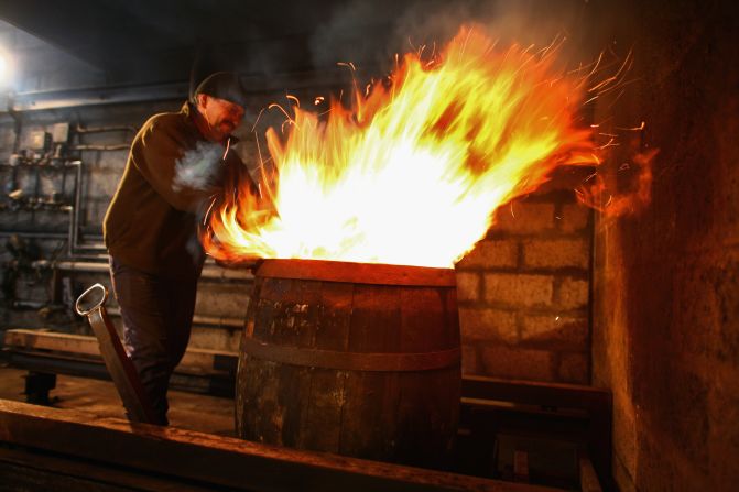 Flames are fired into whiskey barrels to char them, helping release flavor from the wood.<br />