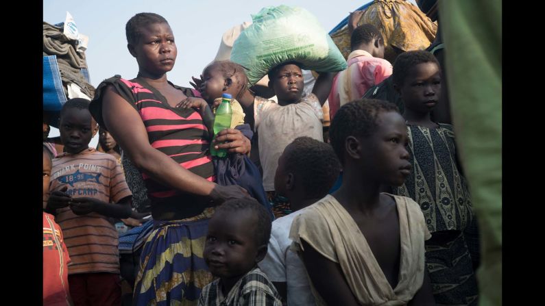 A South Sudanese family moving from Palorinya reception centre, which has a capacity of 3000 people to the Palorinya settlements where each family will be given a piece of land for shelter.