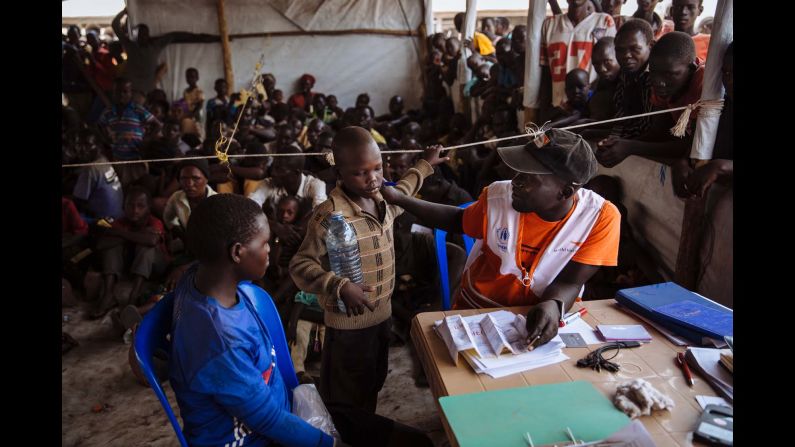 A UNHCR partner speaking with a South Sudanese refugee as he registers a family at the Imvepi Reception Centre, Arua District, Northern Region, Uganda.