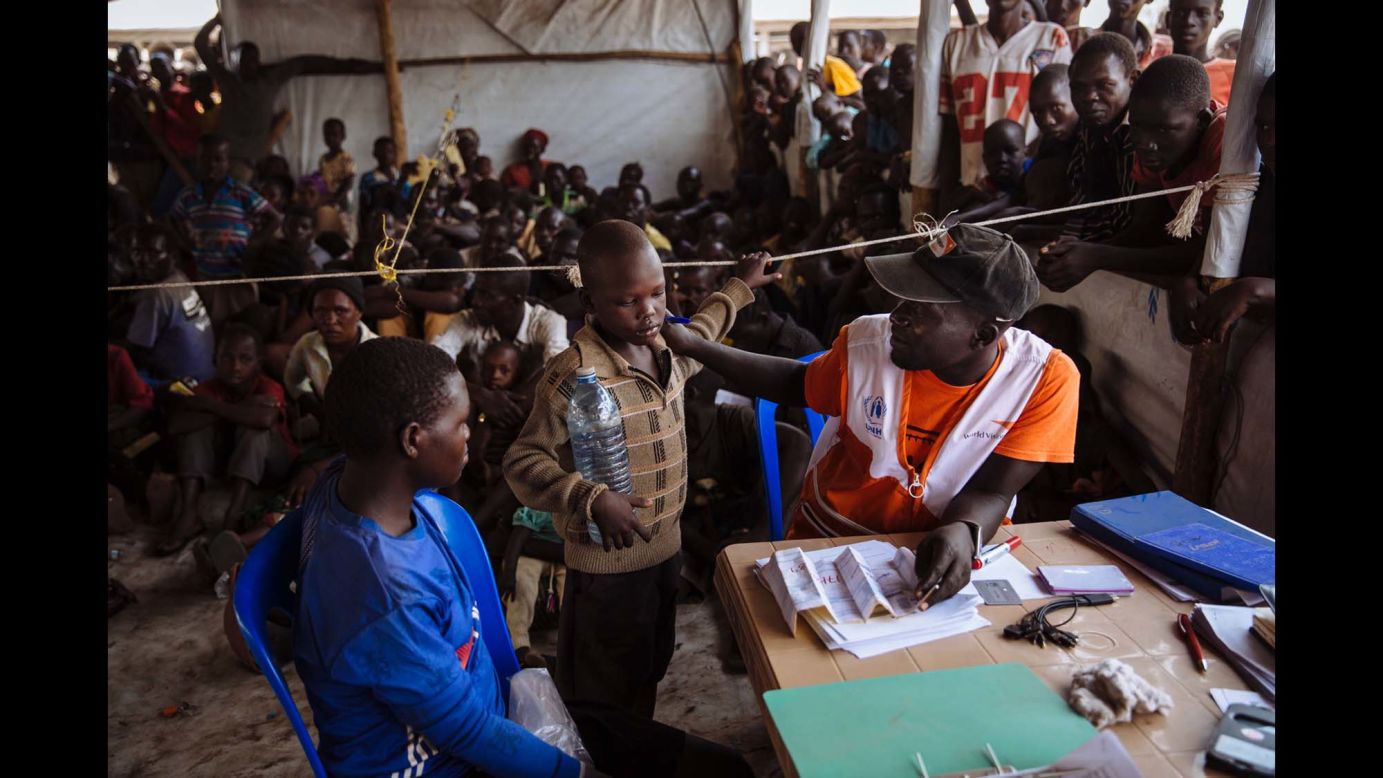A UNHCR partner speaking with a South Sudanese refugee as he registers a family at the Imvepi Reception Centre, Arua District, Northern Region, Uganda.