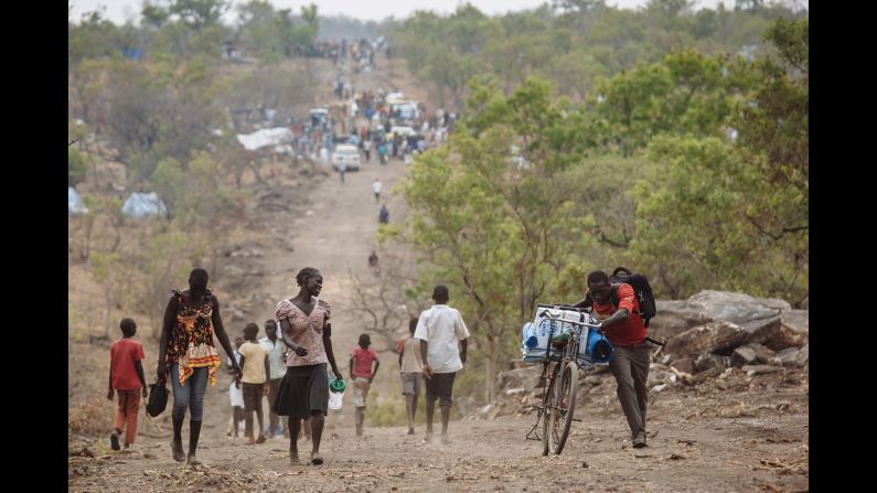 South Sudanese refugees walking down a road in Bidibidi refugee settlement, Yumbe District, Northern Region, Uganda.