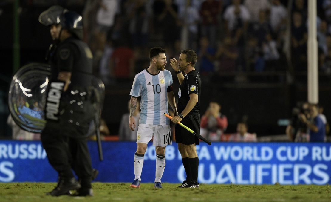 Lionel Messi speaks with the assistant referee during Argentina's win over Chile.