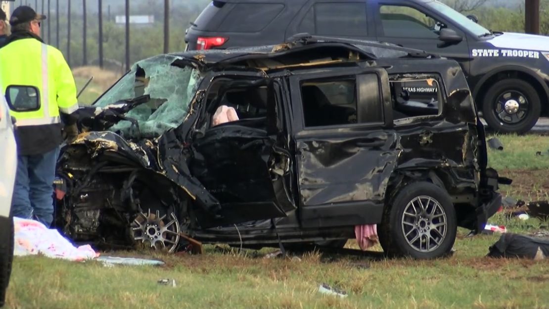 Authorities inspect one of two vehicles involved in a crash that killed three storm chasers in Texas.