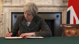 British Prime Minister Theresa May signs the official letter to European Council President Donald Tusk invoking Article 50 and triggering the Brexit process on March 28, 2017.