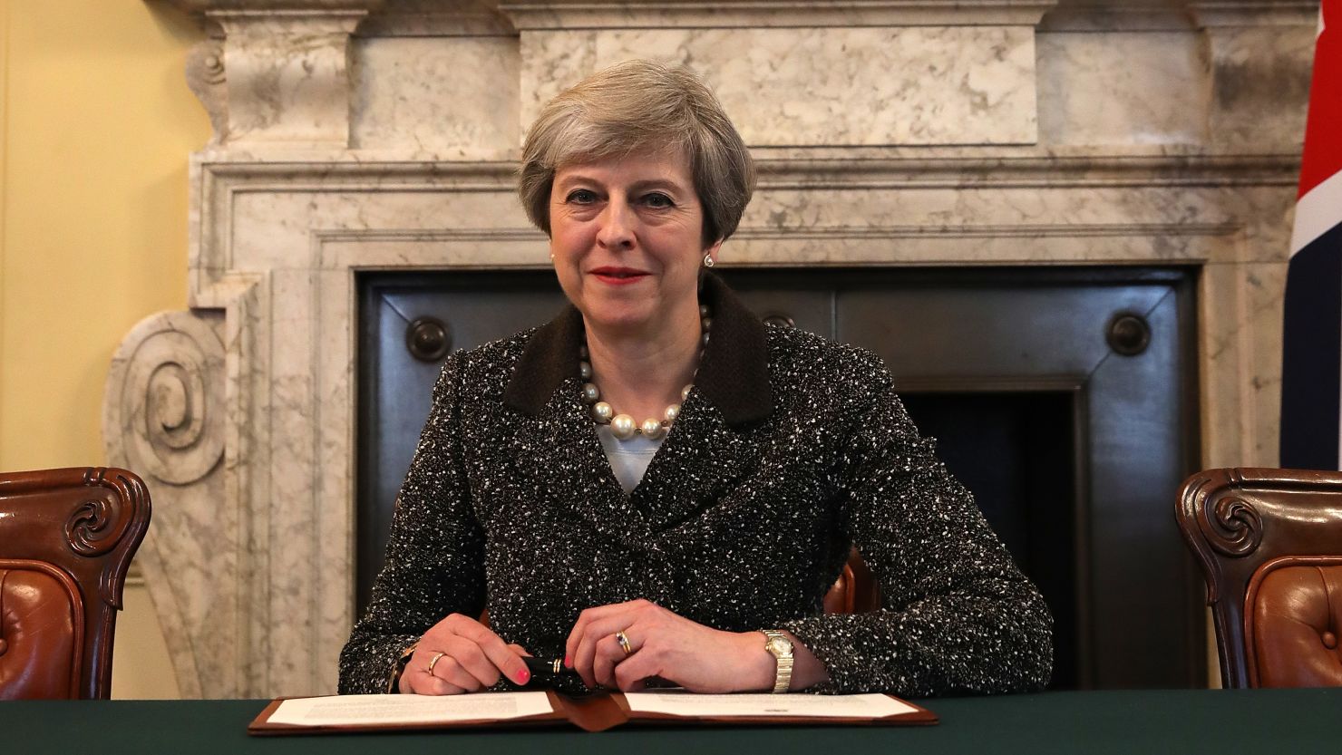 UK Prime Minister Theresa May signs the letter that officially kicked off Brexit in late March.