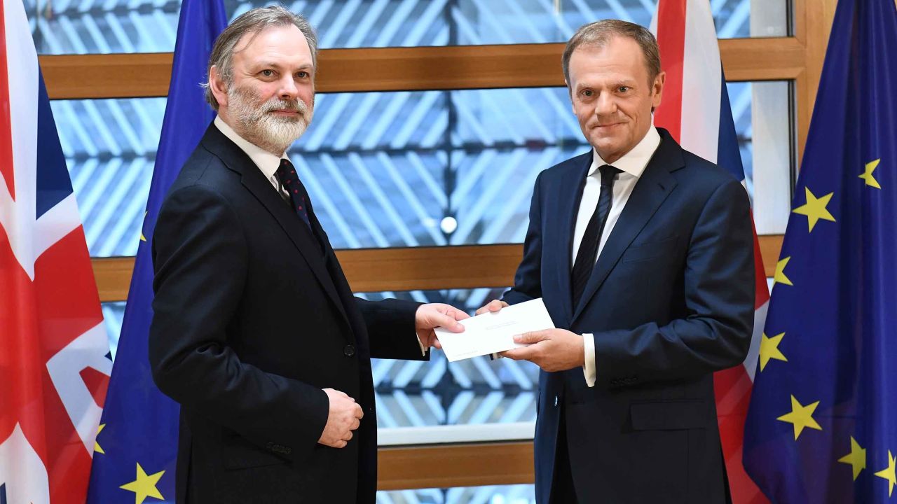 Britain's EU ambassador Tim Barrow delivers the Article 50 letter to European Council President Donald Tusk