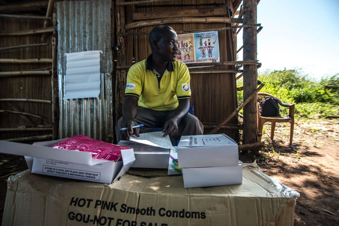 A member of staff from IPPF-affiliated Reproductive Health Uganda distributes free condoms during a mobile clinic visit to the village of Ochaga, near Gulu, Uganda.