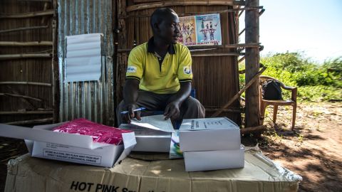 A member of staff from IPPF-affiliated Reproductive Health Uganda distributes free condoms during a mobile clinic visit to the village of Ochaga, near Gulu, Uganda.