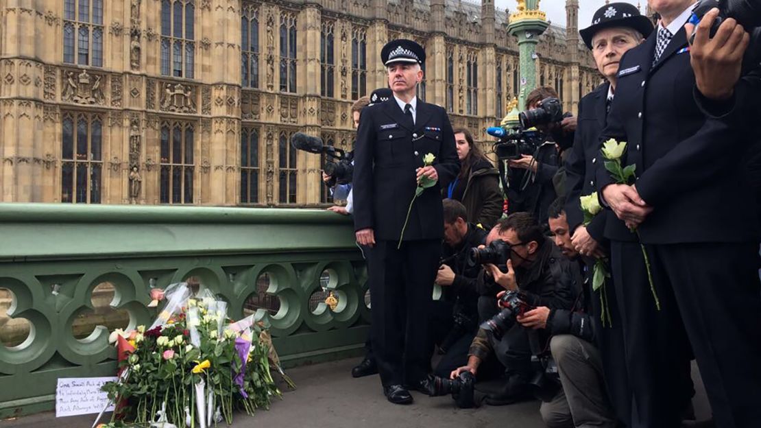 Flowers are laid at a makeshift memorial near the Houses of Parliament.