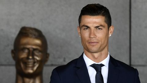 Cristiano Ronaldo poses next to the bronze bust. 