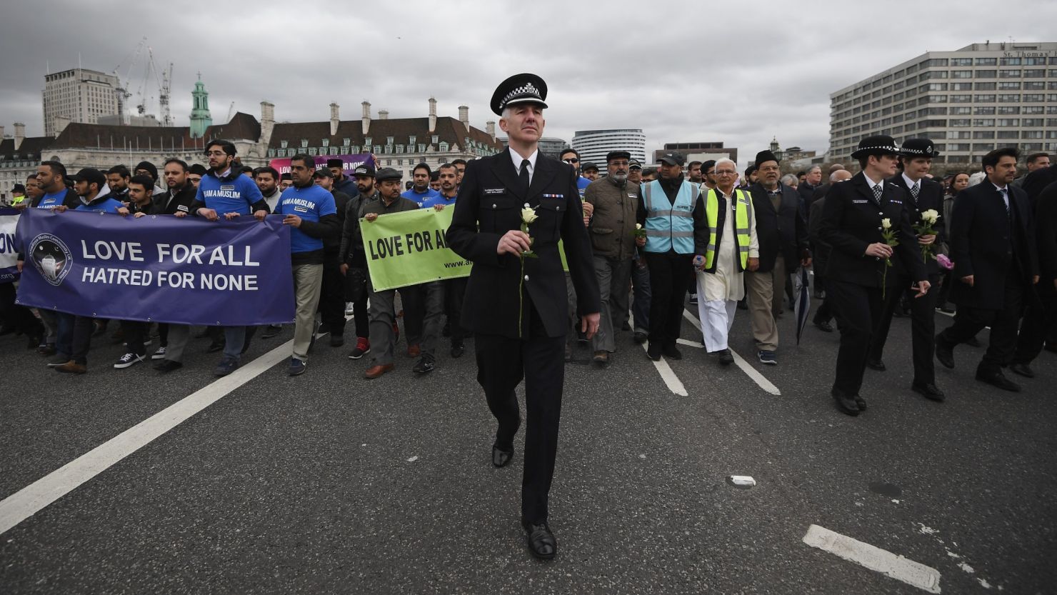 A police officer joins faith leaders at a vigil on Westminster Bridge in London on March 29. 