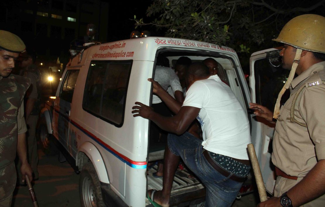 Indian police transport African nationals in Greater Noida, during a violent rampage by local residents.