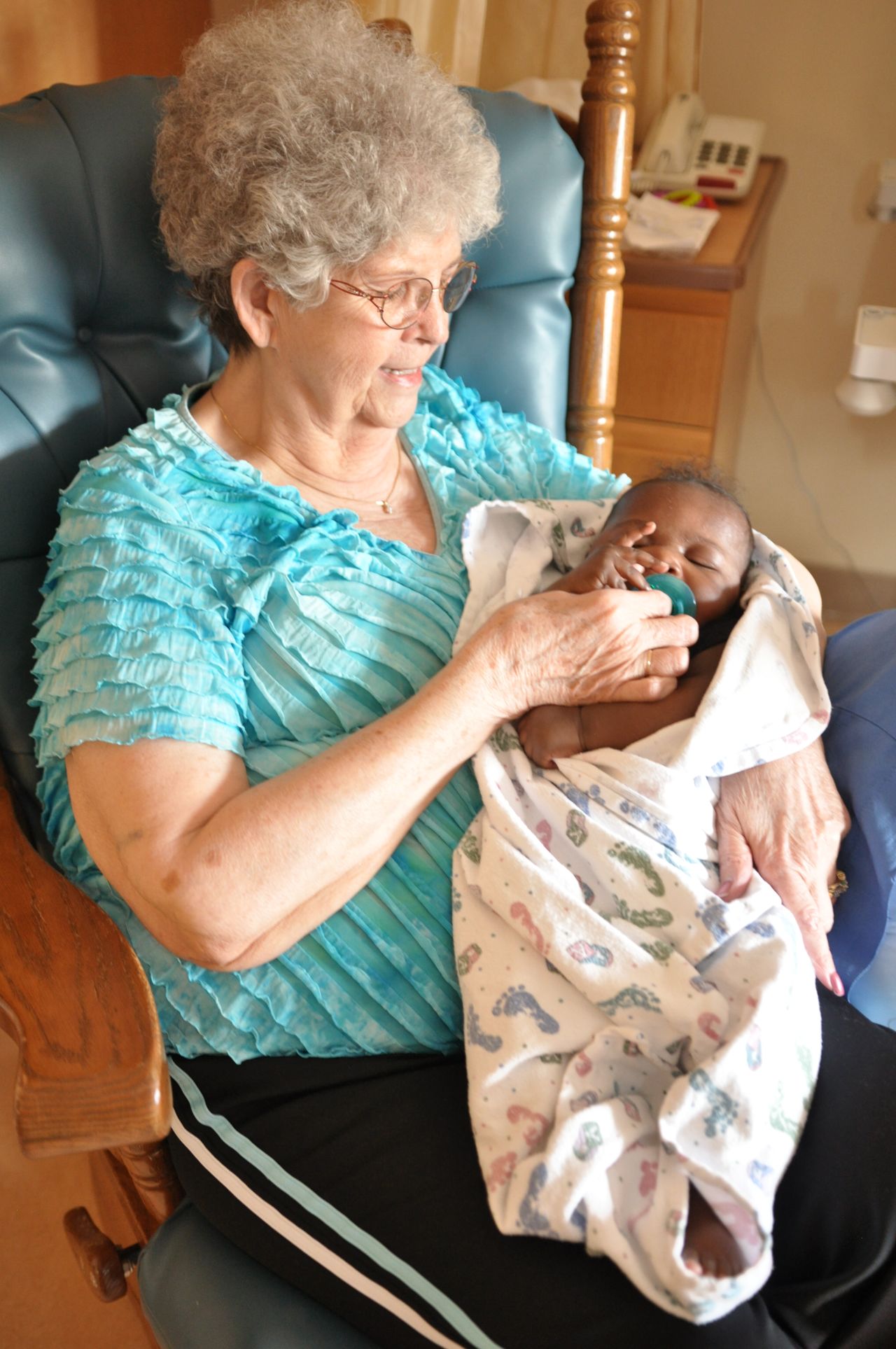 Bess Jensen rocks a baby at Madonna Rehabilitation Hospitals in Lincoln, Nebraska.