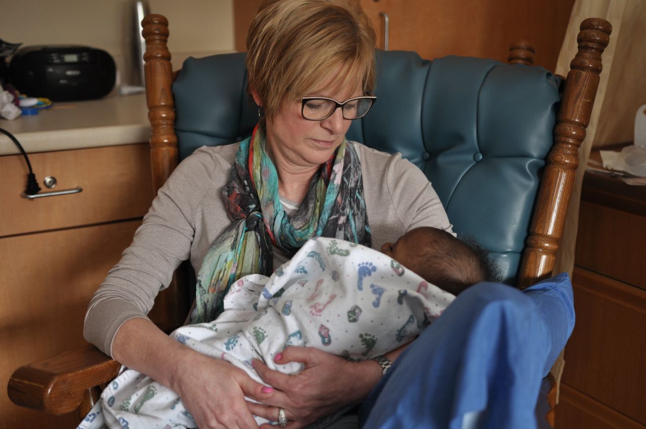 Sandy Ludwig cradles a baby while volunteering at Madonna Rehabilitation Hospitals in Lincoln, Nebraska