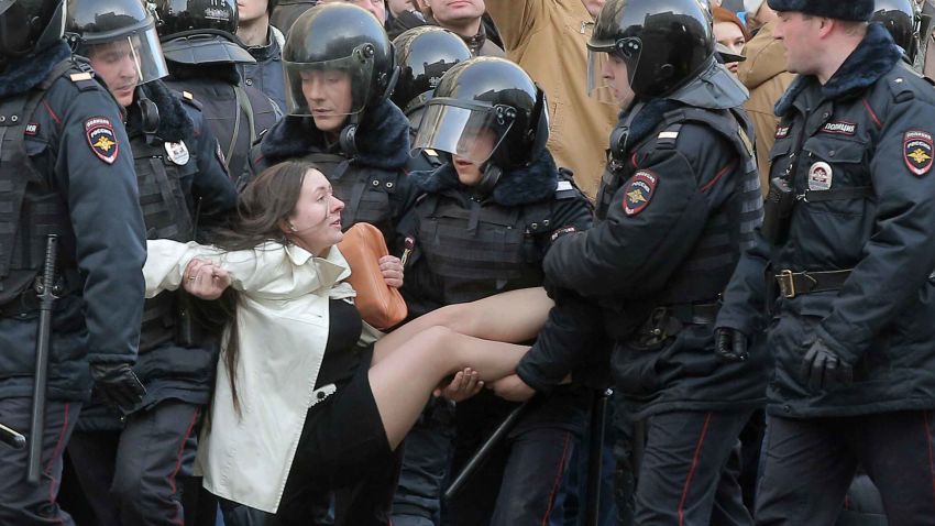 epaselect epa05871912 Russian riot policemen detain a demonstrator during an opposition rally in central Moscow, Russia, 26 March 2017. Russian opposition leader Alexei Navalny called on his supporters to join a demonstration in central Moscow despite a ban from Moscow authorities. Throughout Russia the opposition held the so-called anti-corruption rallies. According to reports, dozens of demonstrators have been detained across the country as they called for the resignation of Russian Prime Minister Dmitry Medvedev over corruption allegations.  EPA/MAXIM SHIPENKOV