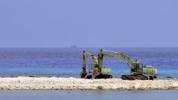 Two excavators are pictured at a construction site on Taiping island in the Spratly chain in the South China Sea on March 23, 2016.
Taiwan on March 23 gave its first ever international press tour of a disputed island in the South China Sea to boost its claim, less than two months after a visit by its leader sparked protests from rival claimants.
 / AFP / SAM YEH        (Photo credit should read SAM YEH/AFP/Getty Images)