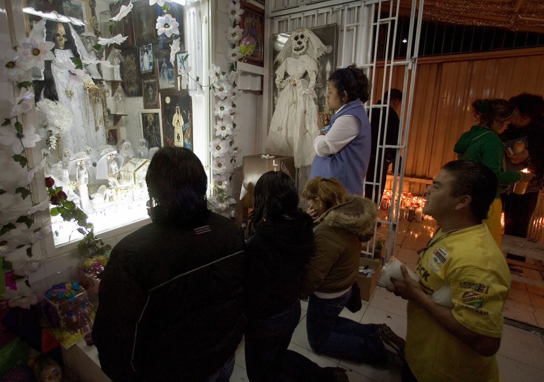 Santa Muerte devotees pray at the shrine in Tepito.