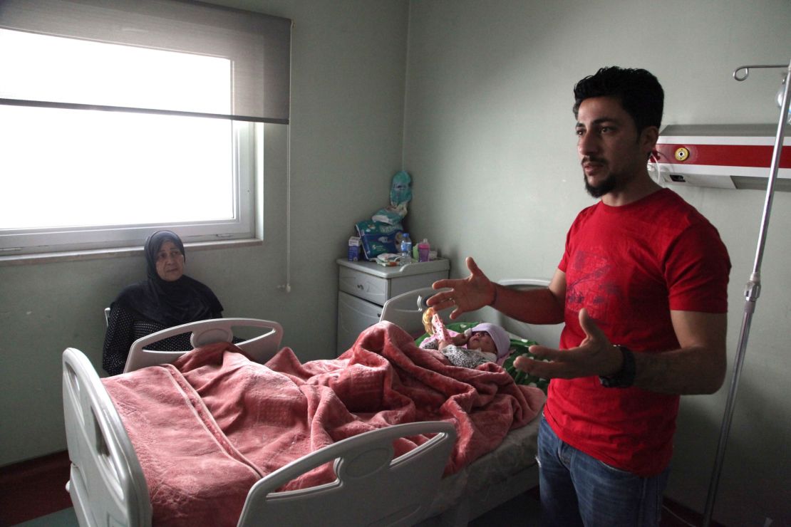Ala'a Al-Tai describes how he and his mother, Aliya (sitting on the left), pleaded with ISIS fighters to let them leave and find treatment for his wounded daughter, who is now recovering at West Erbil emergency hospital.
