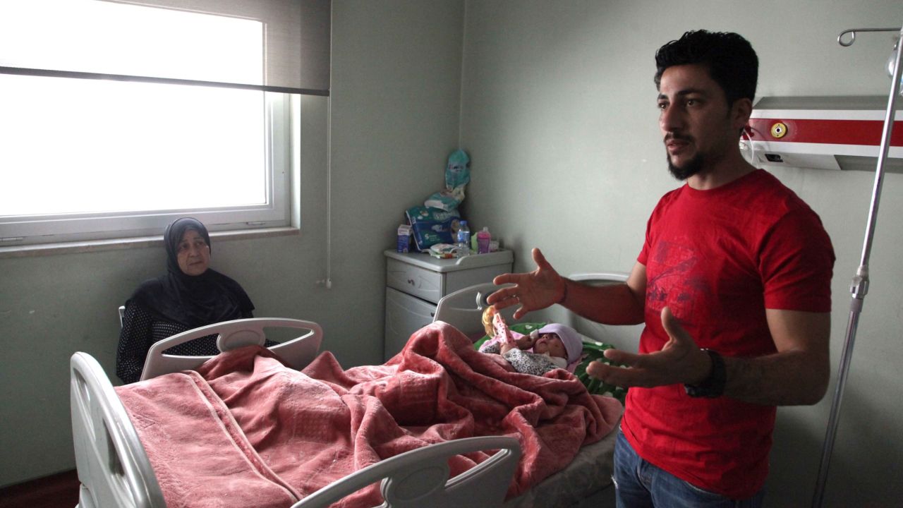 Ala'a Al-Tai describes how he and his mother, Aliya (sitting on the left), pleaded with ISIS fighters to let them leave and find treatment for his wounded daughter, who is now recovering at West Erbil emergency hospital.