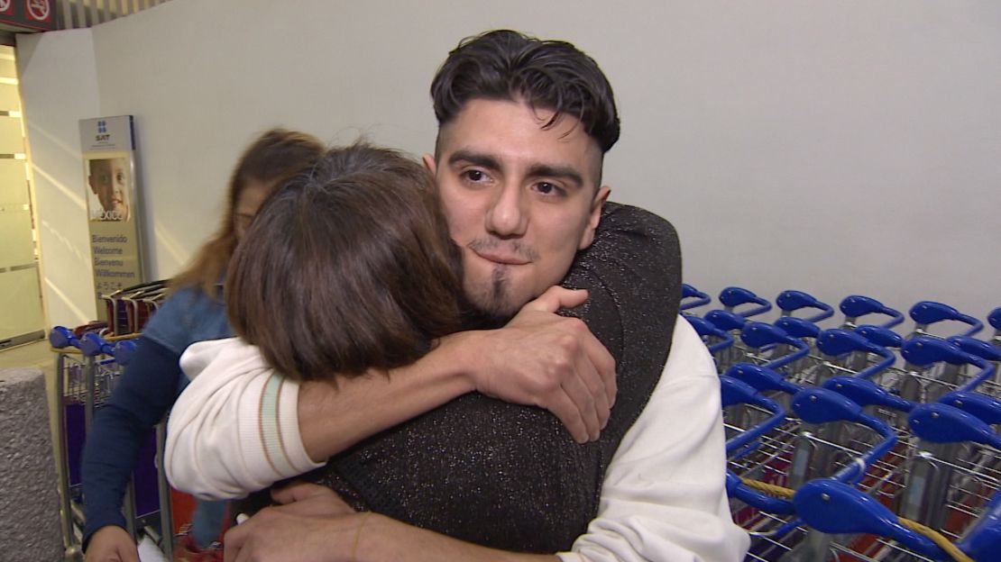 Family members rush to hug Eduardo Hernandez after he arrives in Mexico City on a deportation flight.