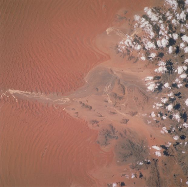 Winds moving north caused the deep red dunes that can be seen in this image of the Sossus Vlei clay pan in Namibia, taken by an astronaut in 2001. 
