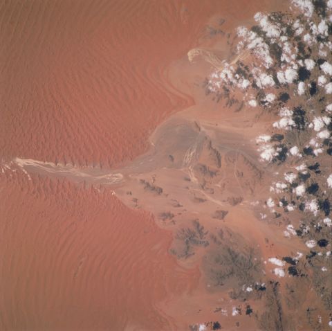 Winds moving north caused the deep red dunes that can be seen in this image of the Sossus Vlei clay pan in Namibia, taken by an astronaut in 2001. 