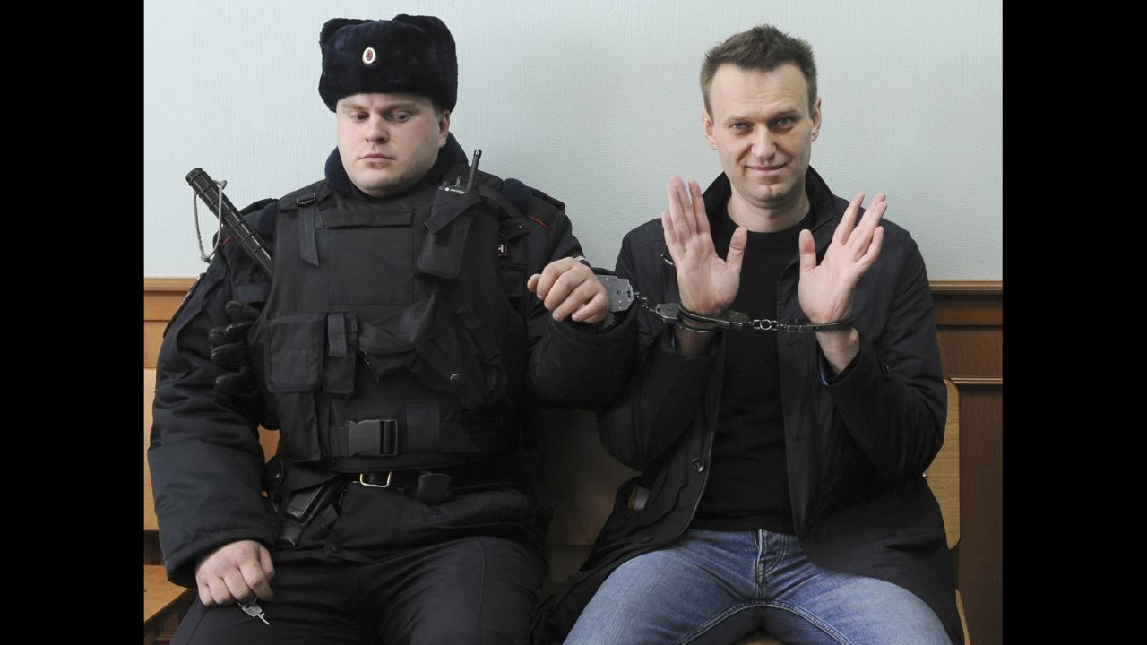 Russian opposition leader Alexei Navalny, right, poses for the press as he sits in a Moscow court on Thursday, March 30. Navalny <a href="http://www.cnn.com/2017/03/27/europe/russia-navalny-moscow-protests/" target="_blank">was jailed for 15 days</a> over his role in a mass anti-corruption protest.