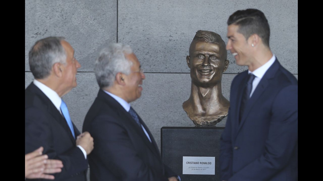 Soccer star Cristiano Ronaldo, right, is joined by Portuguese President Marcelo Rebelo de Sousa, left, and Prime Minister Antonio Costa after the Madeira Airport <a href="http://www.cnn.com/2017/03/29/football/cristiano-ronaldo-airport-madeira-bust-statue-unveiling/" target="_blank">was renamed in his honor</a> on Wednesday, March 29. The bronze bust of Ronaldo stole many of the headlines, especially on social media. 